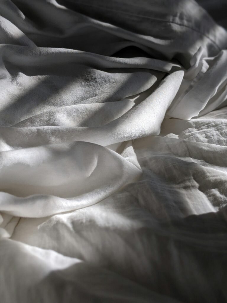 Soft, white fabric with gentle folds.